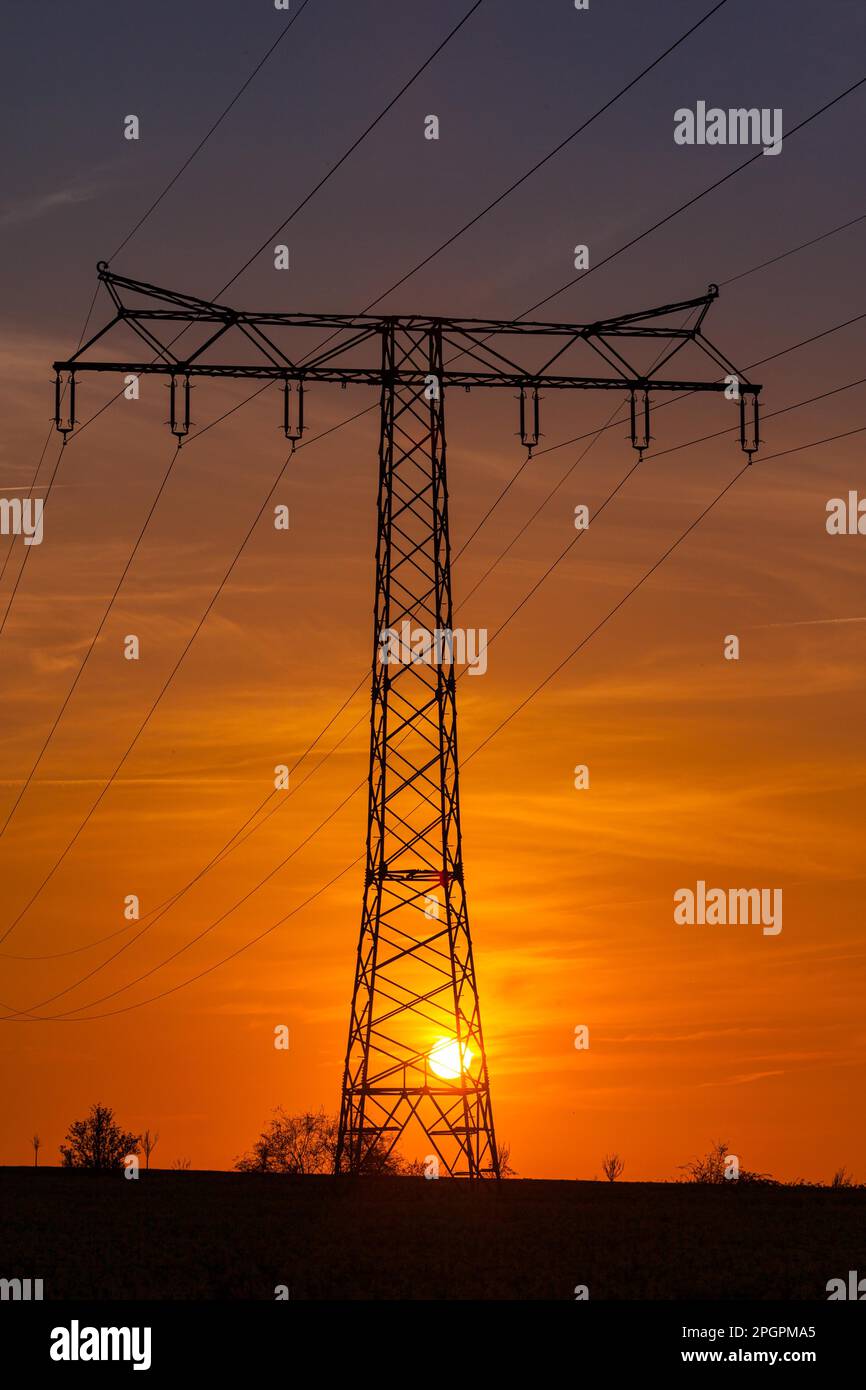 Highvoltage power line Highvoltage pylon in the sunset Stock Photo