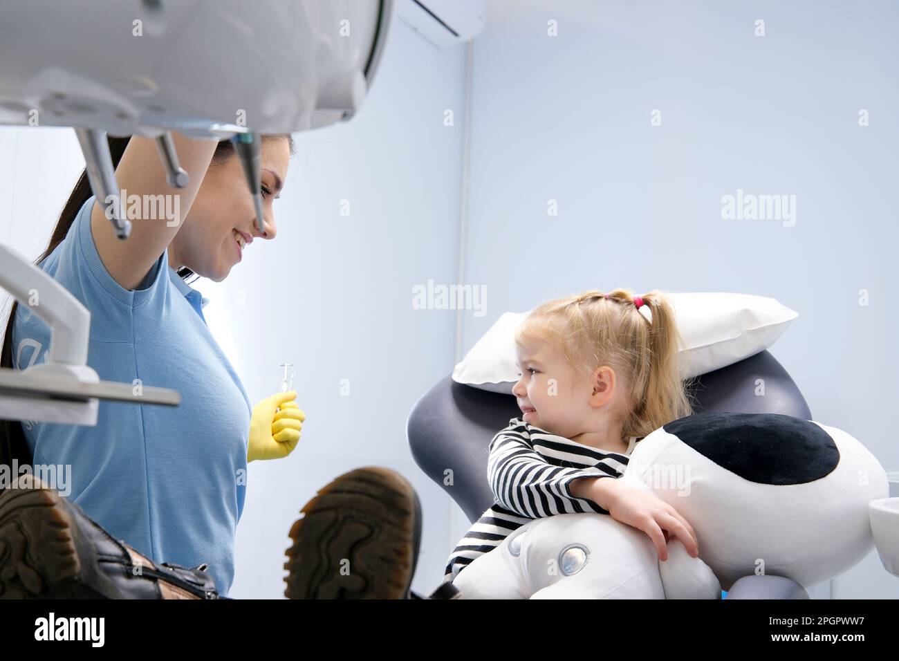 Part of orthodontist examining child's teeth in dentist's office. High ...