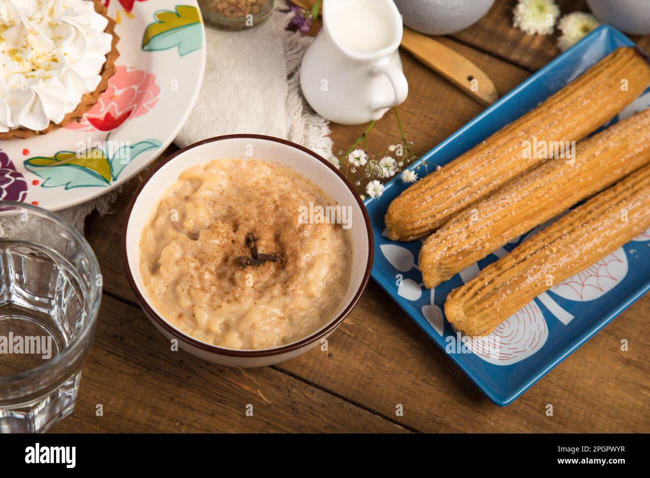 Arroz con leche and churros Peruvian desserts buffet table brunch sweet food Stock Photo