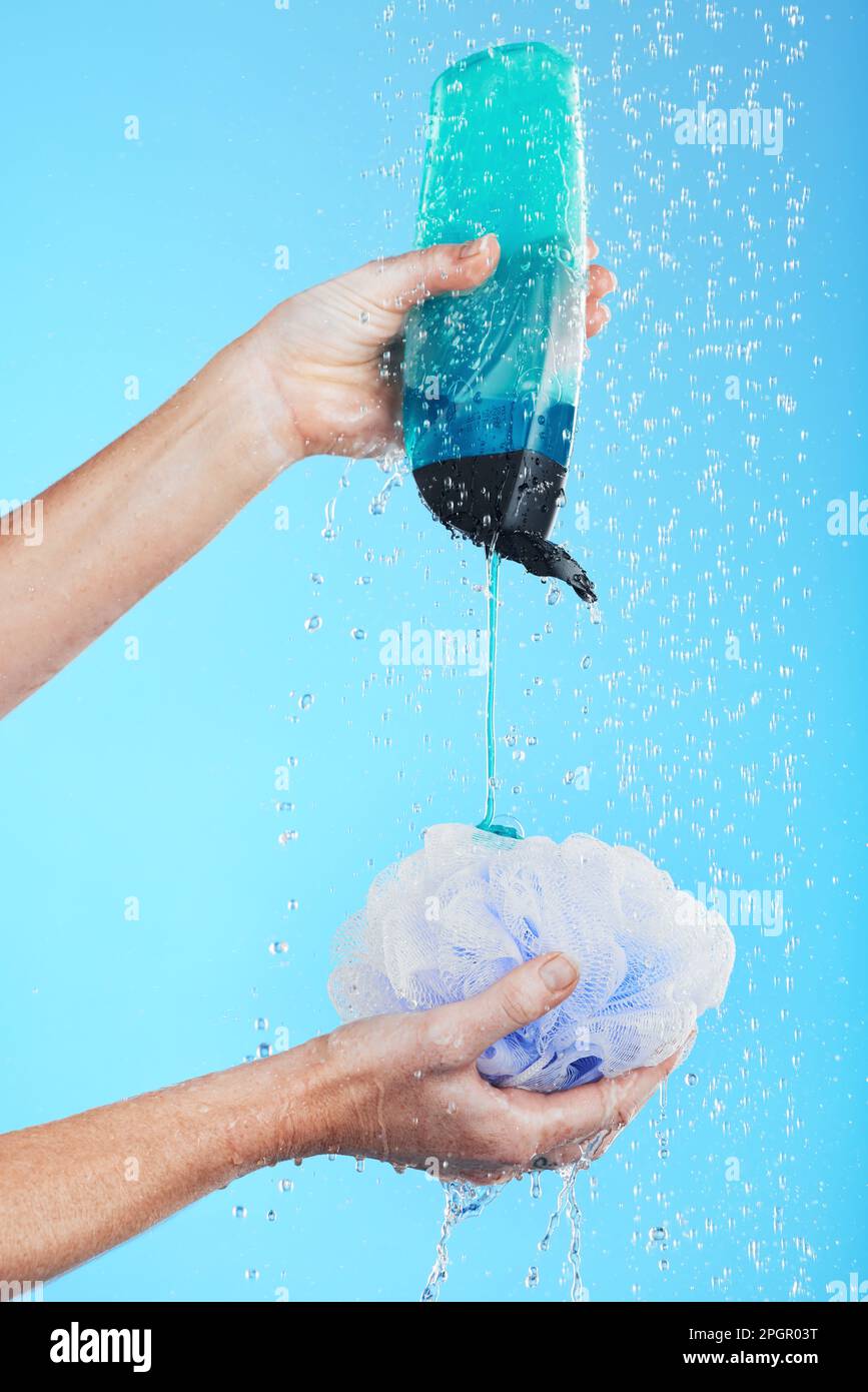 Skincare, product and hands with loofah and shower gel of person washing  isolated in a studio blue background. Self care, beauty and person or model  Stock Photo - Alamy