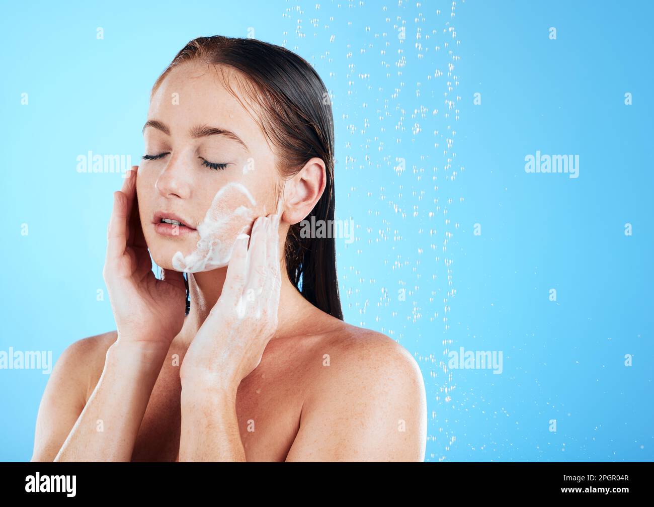 Woman face wash, shower water and studio with a young female doing skincare and beauty routine