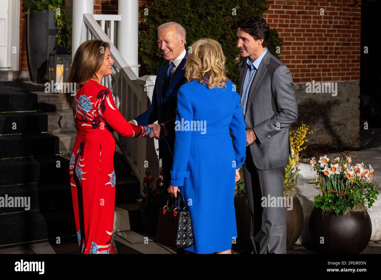 U.S. President Joe Biden (L2) shakes hands with Canadian First Lady Sophie Grégoire Trudeau (L) while Canadian Prime Minister Justin Trudeau (R) speaks with U.S. First Lady Jill Biden (C) during Biden's first official visit to the country since he became president, outside of Rideau Cottage in Ottawa. Though visits from American presidents to Canada typically take place soon after election, Biden's inaugural visit to the northern neighbour has been delayed due to COVID-19 travel restrictions. (Photo by Katherine Cheng/SOPA Images/Sipa USA) Stock Photo