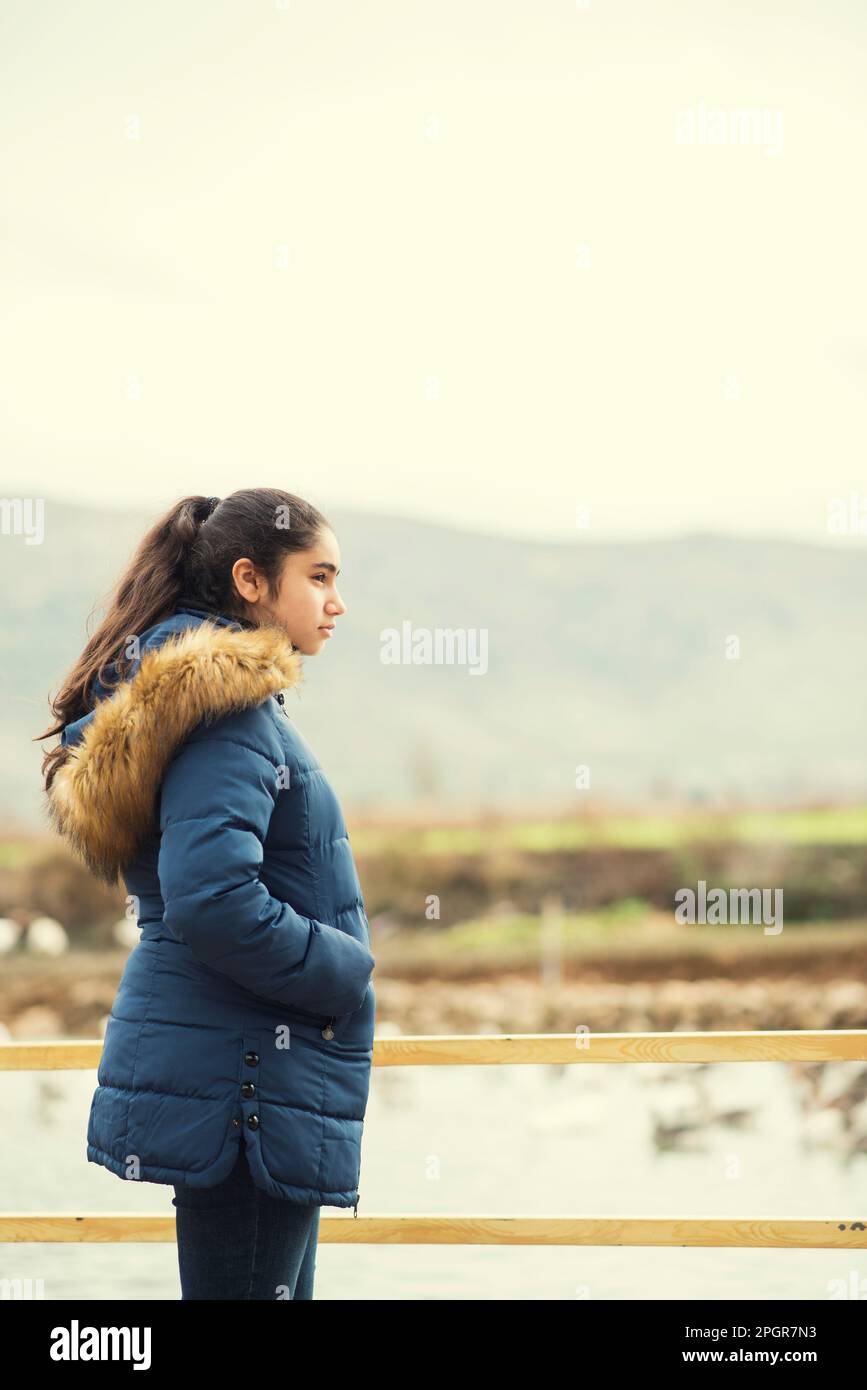 Side view of beautiful teenage girl looking away outdoors Stock Photo ...