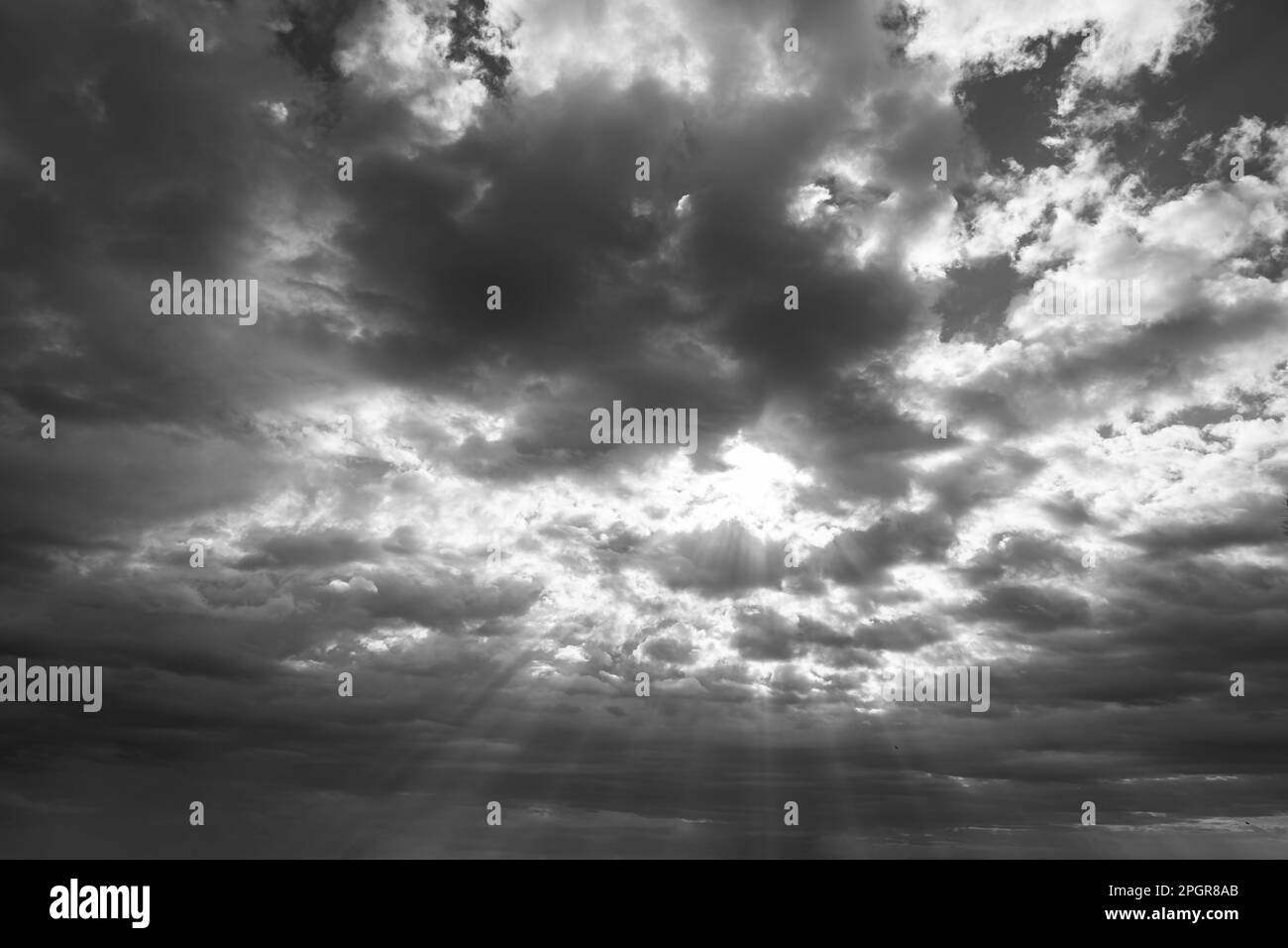 Sunrays and cloudscape. Overcast sky or stormy weather background. Religion or heavenly concept photo. Stock Photo