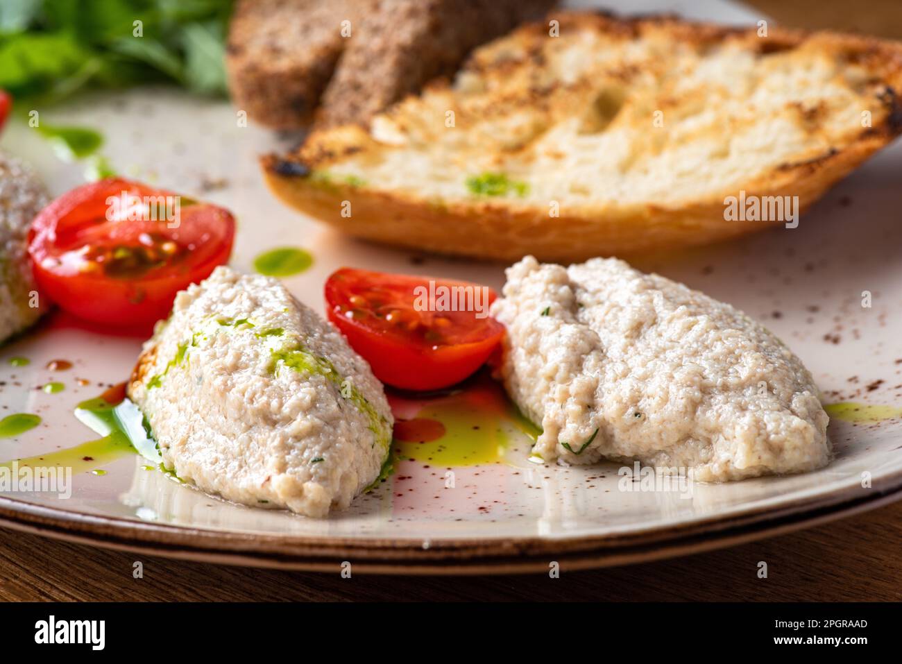 Cod liver pate with brown bread on plate. Homemade spread made from cod