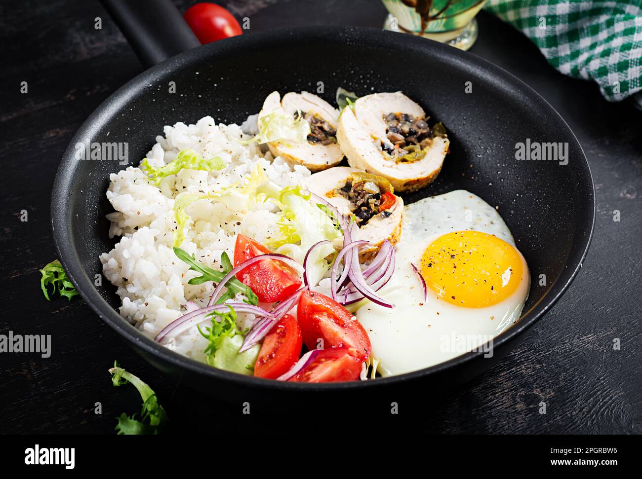 Fried egg, meat chicken roll, rice and tomatoes. Paleo breakfast Stock ...
