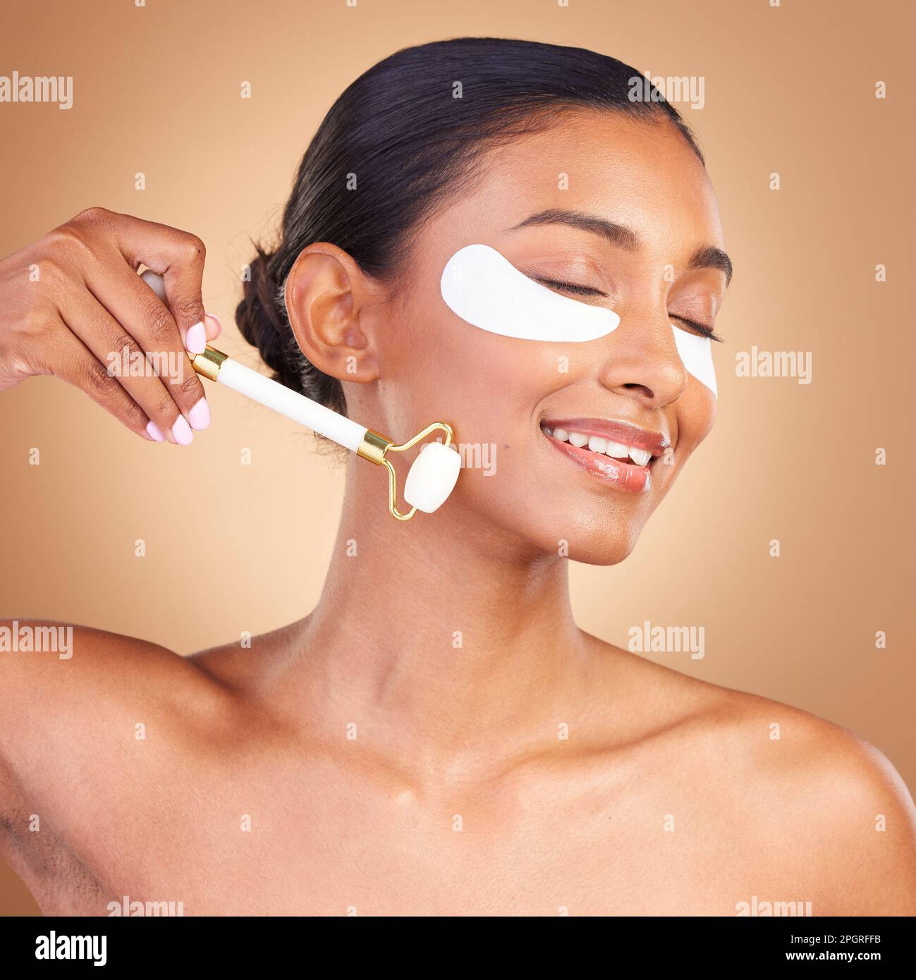 Roller, eye patch and beauty with Indian woman in studio for facial