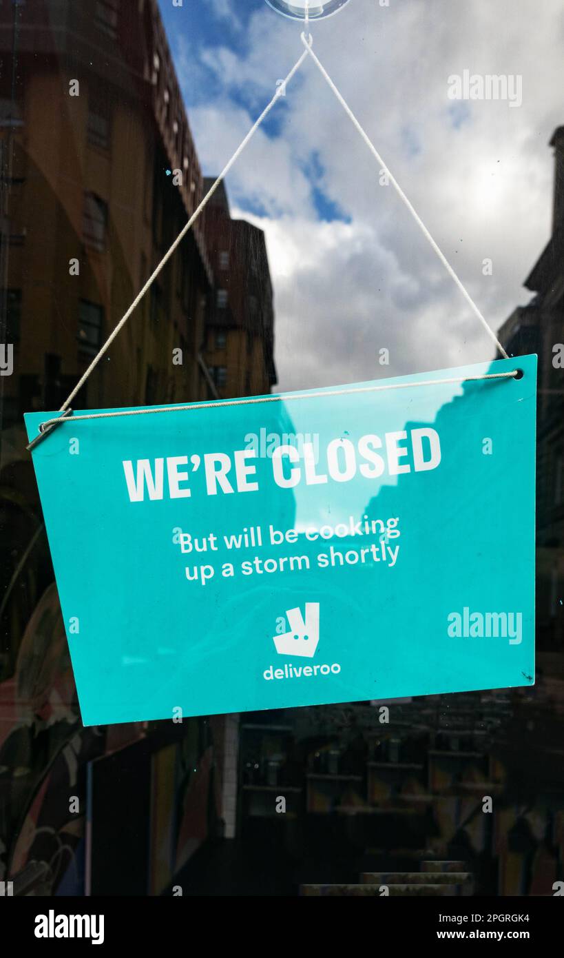 We're Closed sign in window of a restaurant in Liverpool Stock Photo