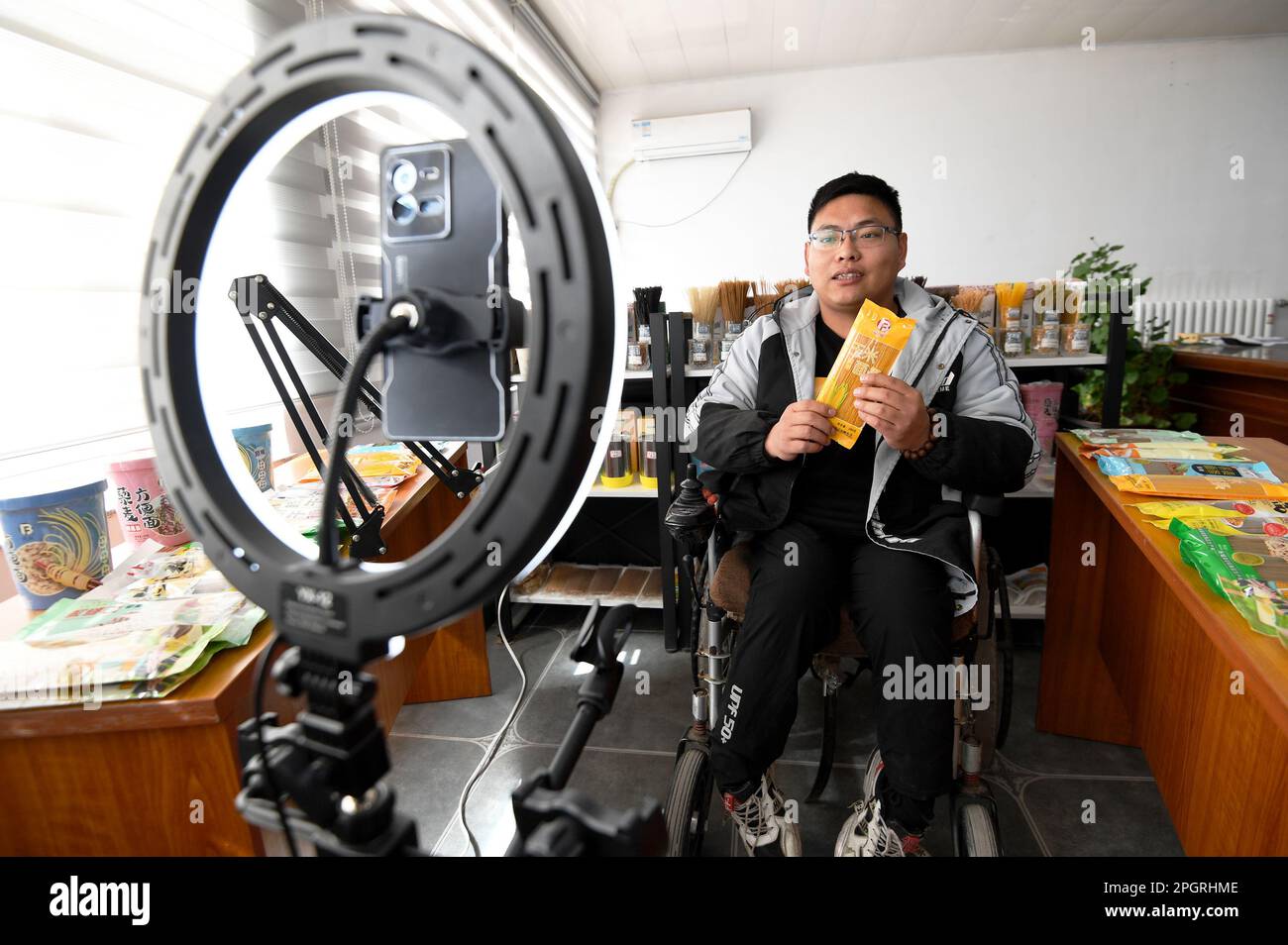 ZHANGJIAKOU, CHINA - MARCH 24, 2023 - An employee sells products via live streaming at Binbin Food Production Co LTD in Chicheng county, Zhangjiakou, Stock Photo