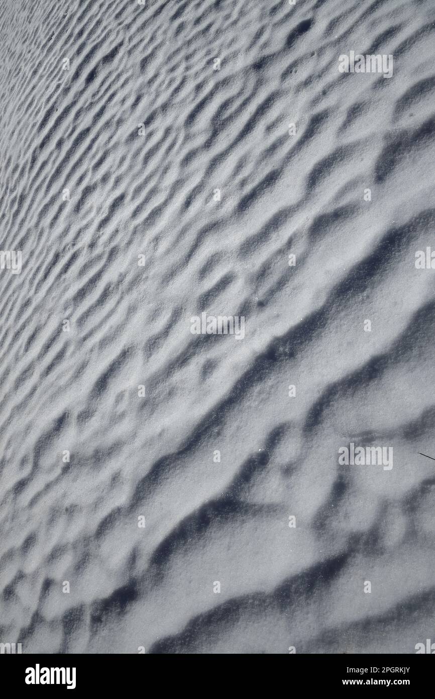 Diagonal shot with wavy snow on an early sunny morning in spring Stock ...