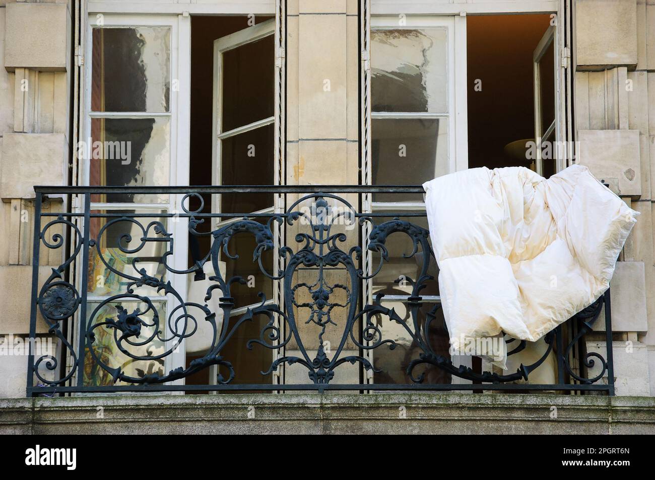 Paris, France. Blanket is dried, hanging out of the window of typical