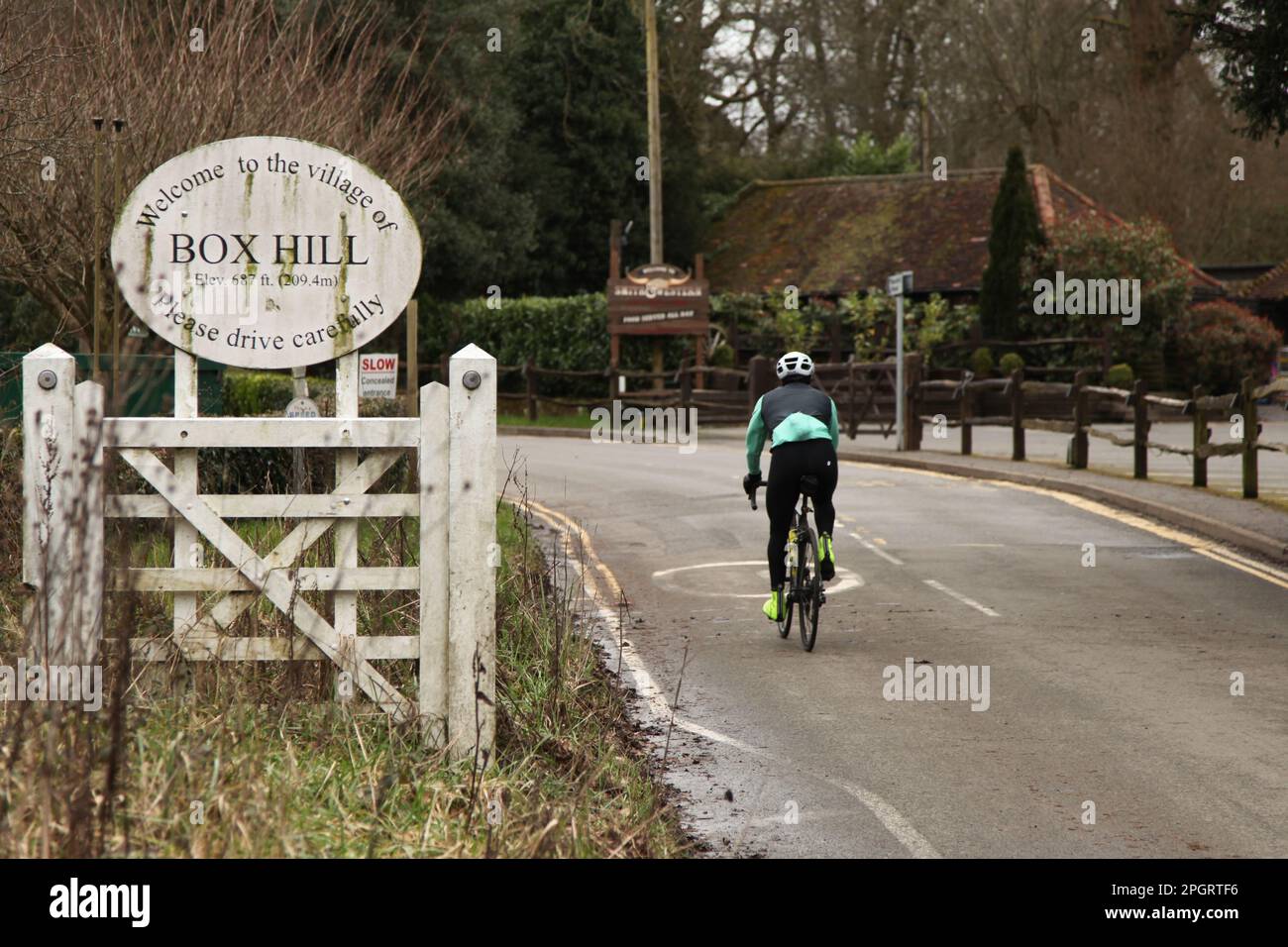 Cyclist riding on Zig Zag road past Smith & Western at National Trust