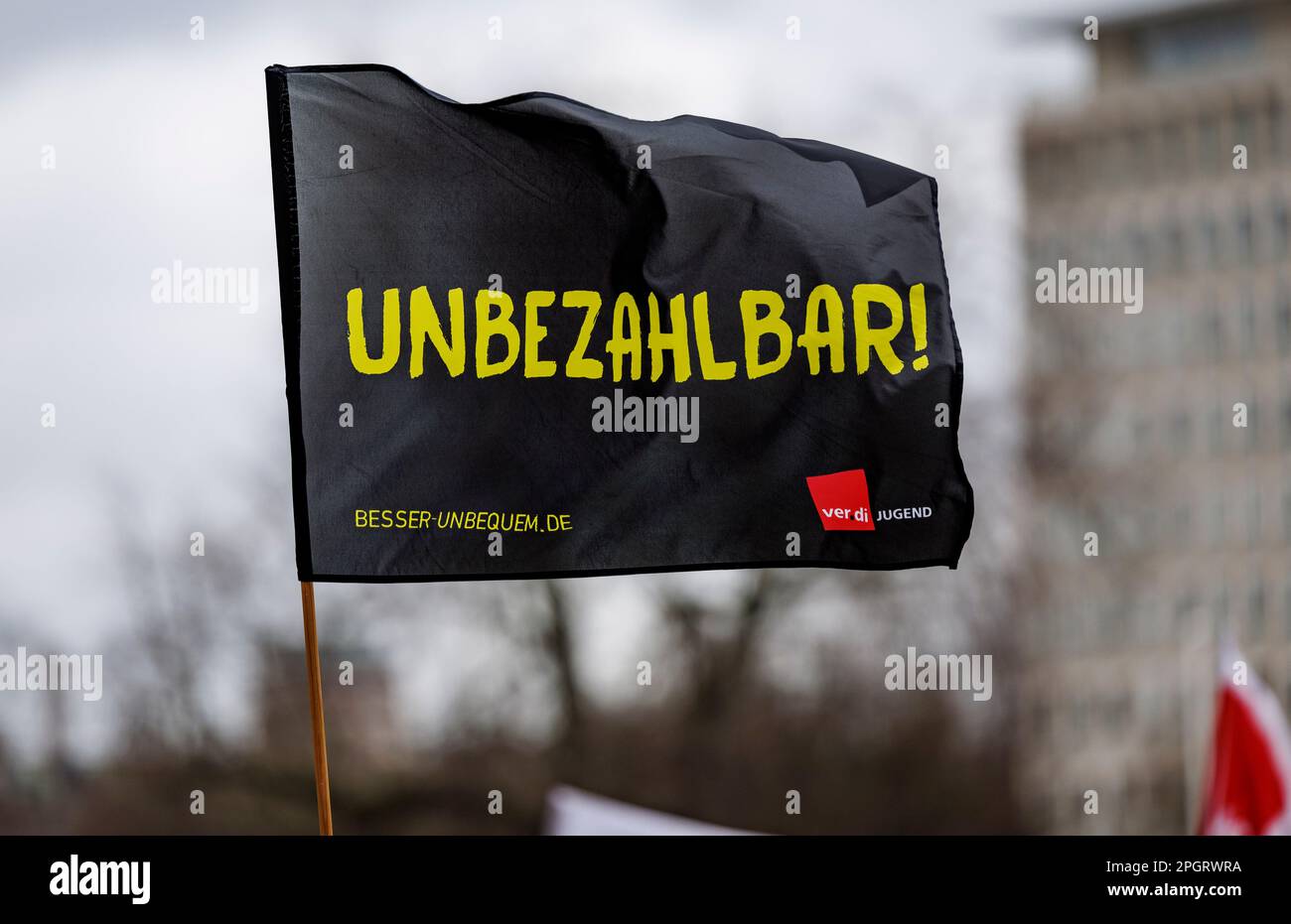 Kiel, Germany. 24th Mar, 2023. A flag of the Verdi youth with the inscription 'Unbezahlbar' flies in front of the city hall. The Verdi trade union has called on public sector employees in Schleswig-Holstein to go on a warning strike. Credit: Axel Heimken/dpa/Alamy Live News Stock Photo