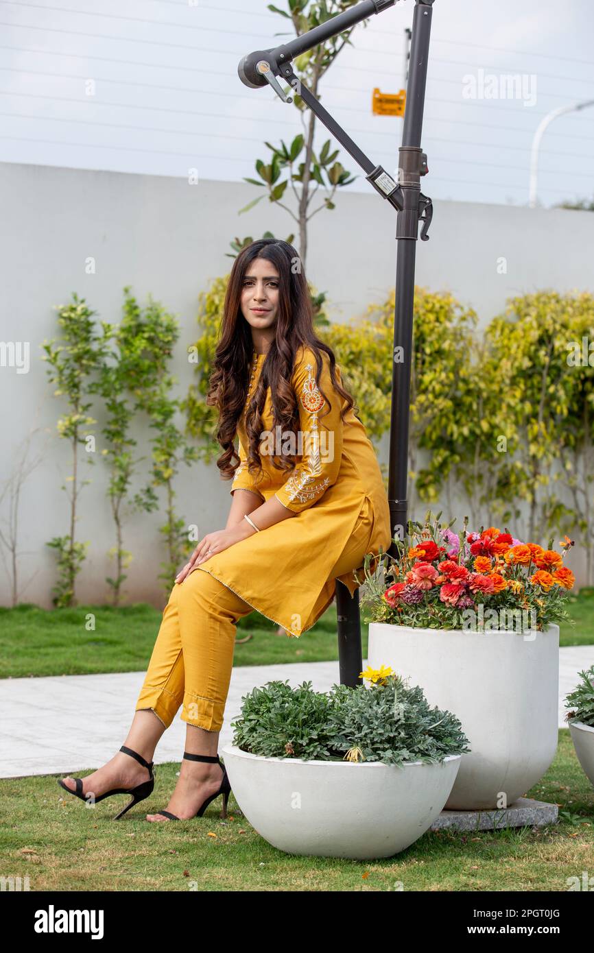 Female model posing outdoors wearing summer dress Indian Pakistani Asian traditional salwar kameez Stock Photo