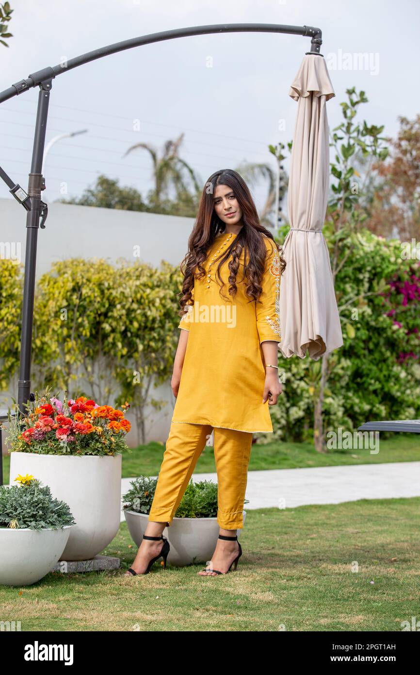 Female model posing outdoors wearing summer dress Indian Pakistani Asian traditional salwar kameez Stock Photo