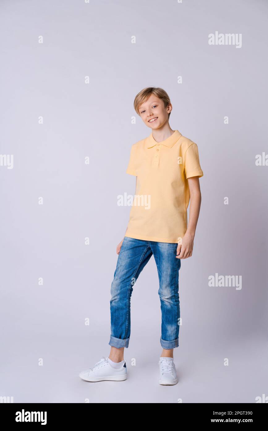 Happy boy Hands raised hands in happiness, wearing yellow t-shirt and ...