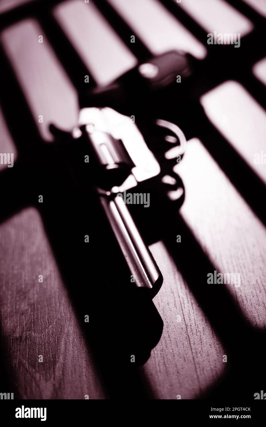 Pistol gun thriller book cover design photo with dramatic dark and light at night. Stock Photo
