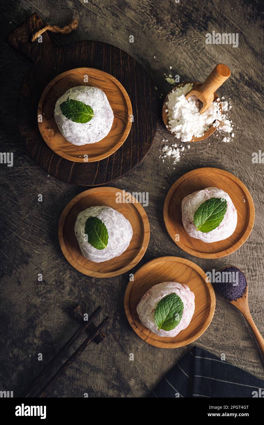 Japanese mochi or rice cake filled with red bean and strawberry, mint leaves on top. Japan traditional rice cake. Stock Photo