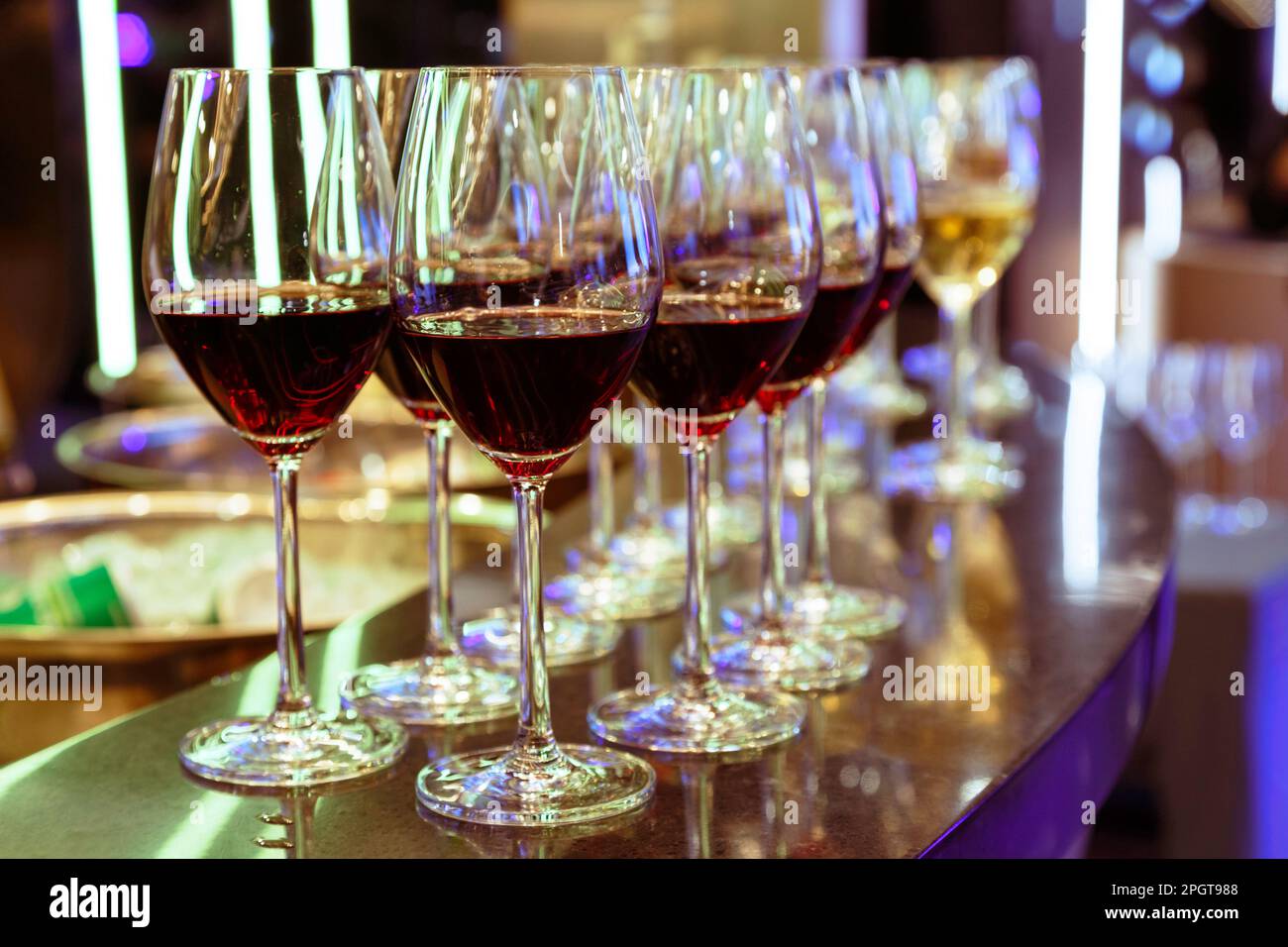 red wine in wine glass on the bar counter ready to serve and drink in