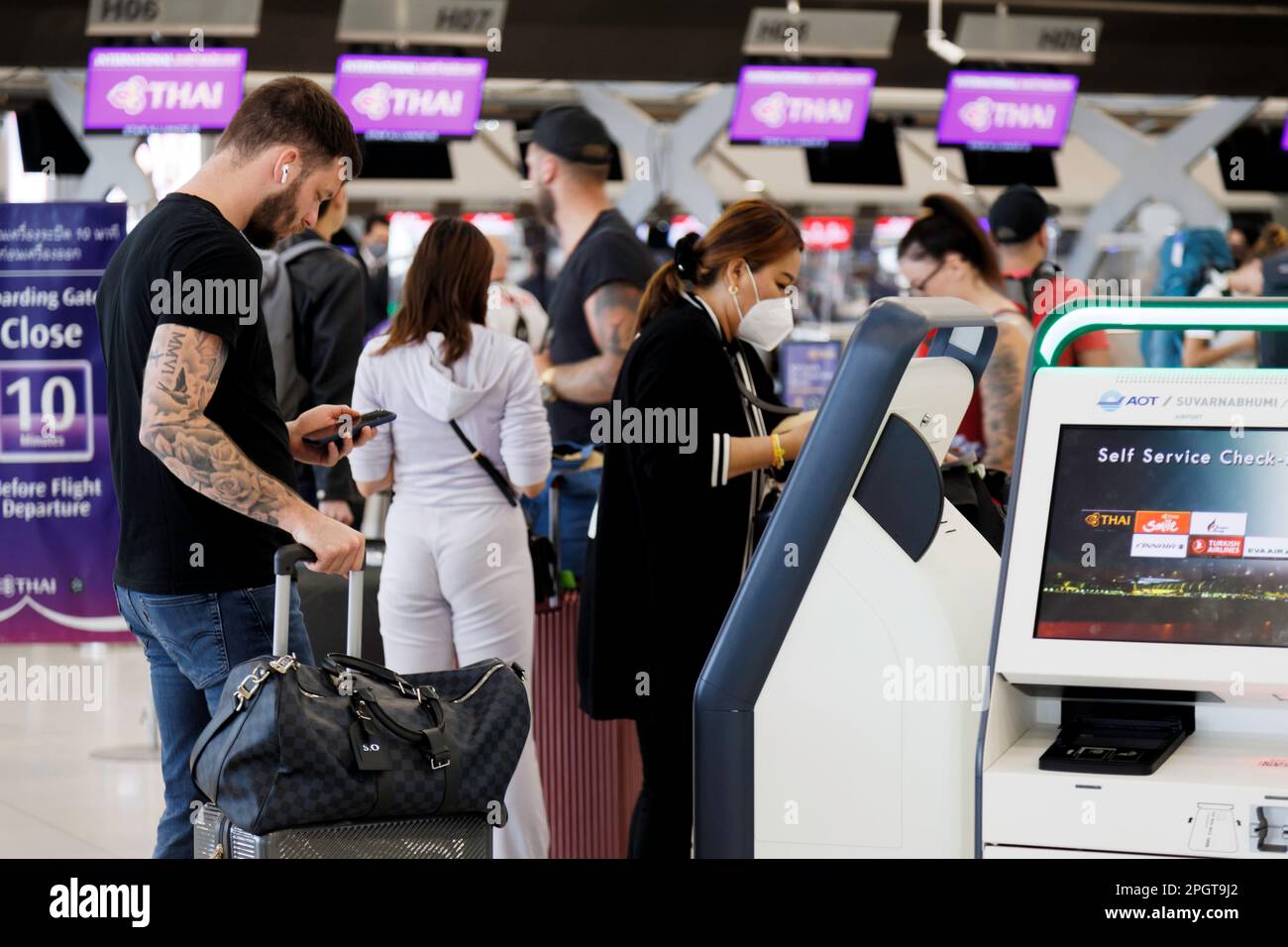 Bangkok, Thailand - March 6, 2023 : tourist visitor self service check in at kiosk machine at suvarnabhumi airport. thailand reopening to travel again Stock Photo