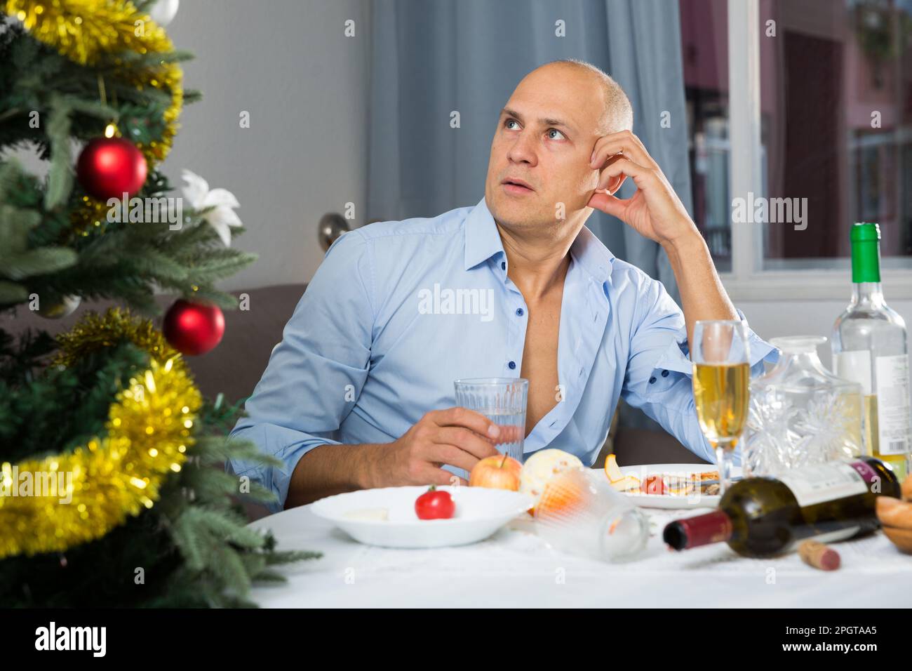Upset man at the New Year table Stock Photo