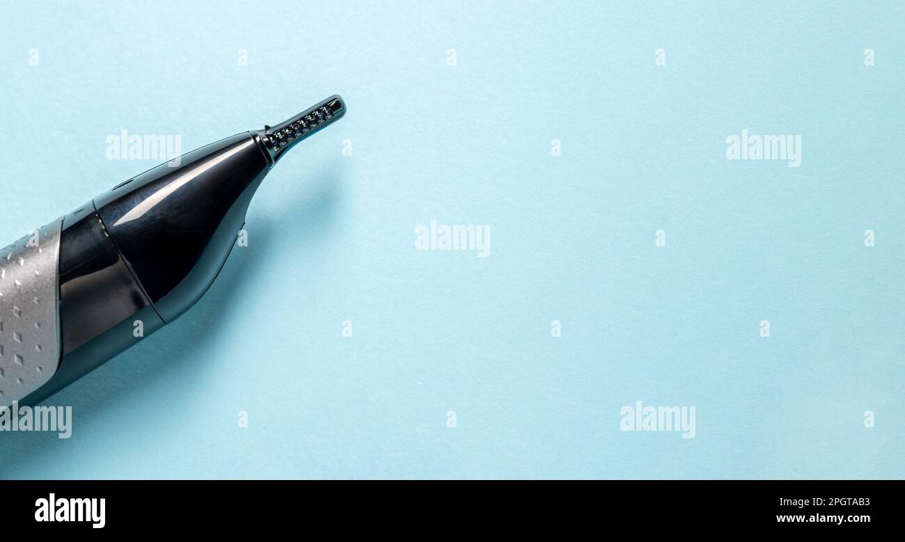 Top view of nose and ear hair trimmer isolated on blue background Stock Photo