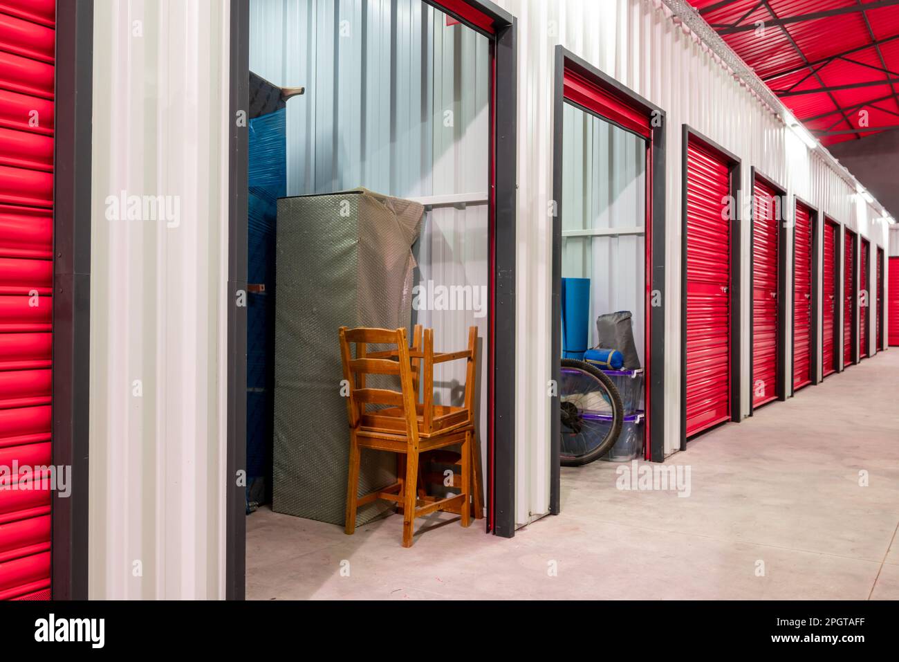 Corridor of self storage unit with red doors. Rental Storage Units