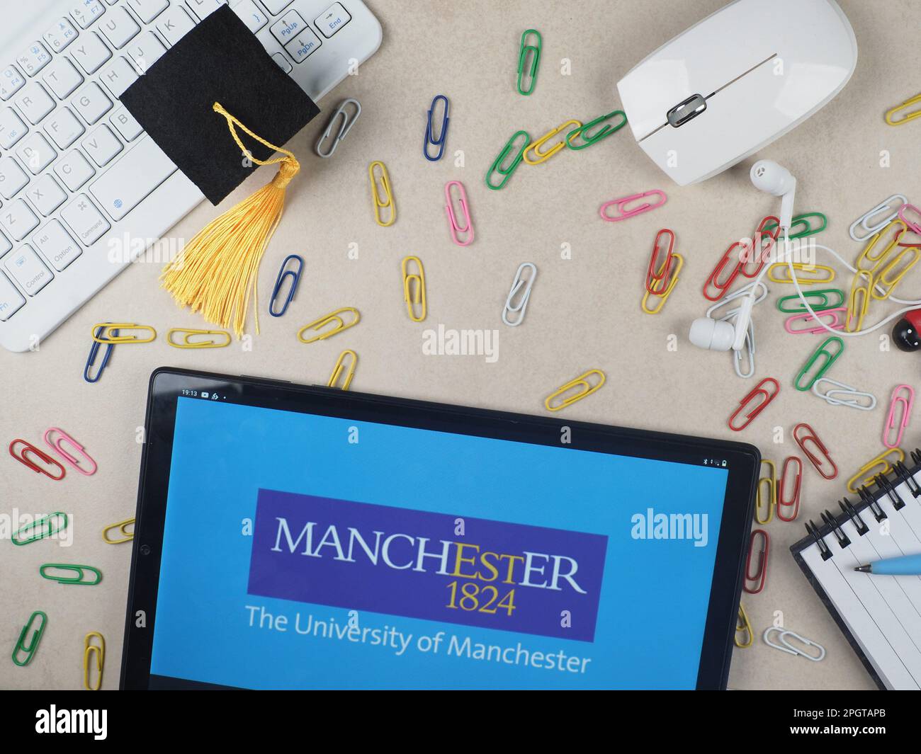 In this photo illustration, The University of Manchester  logo seen displayed on a tablet. Stock Photo