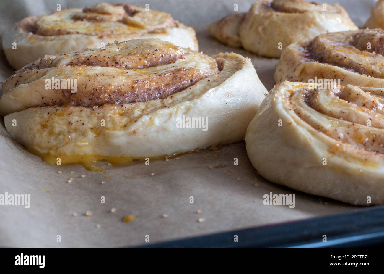 uncooked cinnamon buns decorated with granulated sugar Stock Photo