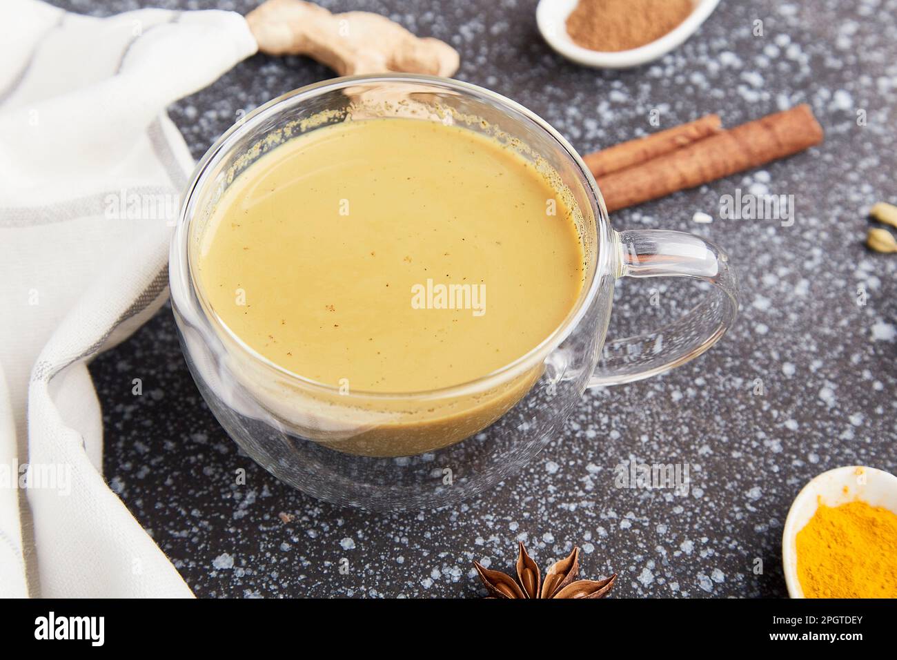 Masala tea with star anise, cinnamon, turmeric spices. Healthy traditional indian organic drink flat lay. Stock Photo