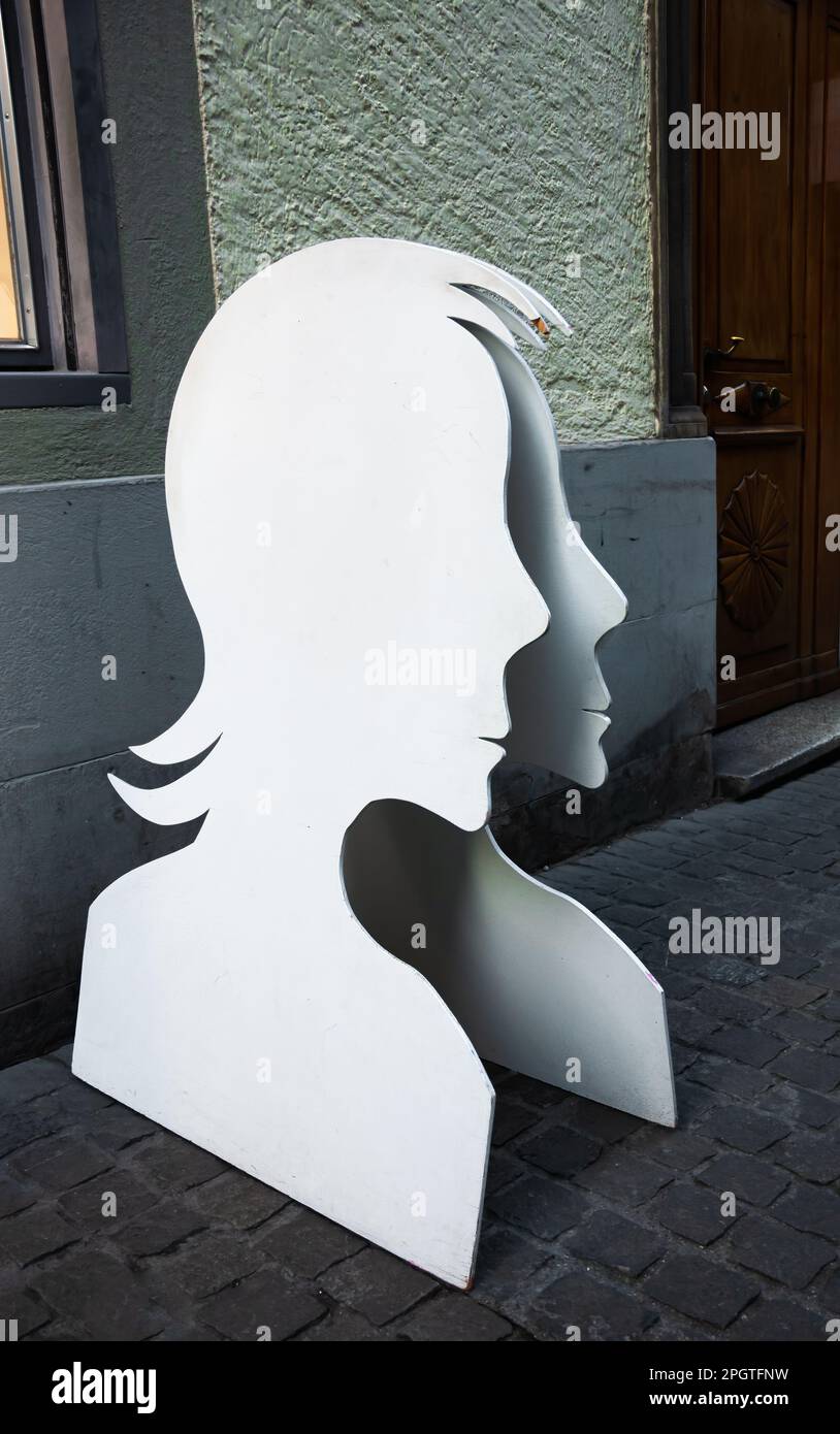 Zurich, Switzerland - February 21, 2023: Silhouettes of human faces on the street of the old town of Zurich Stock Photo