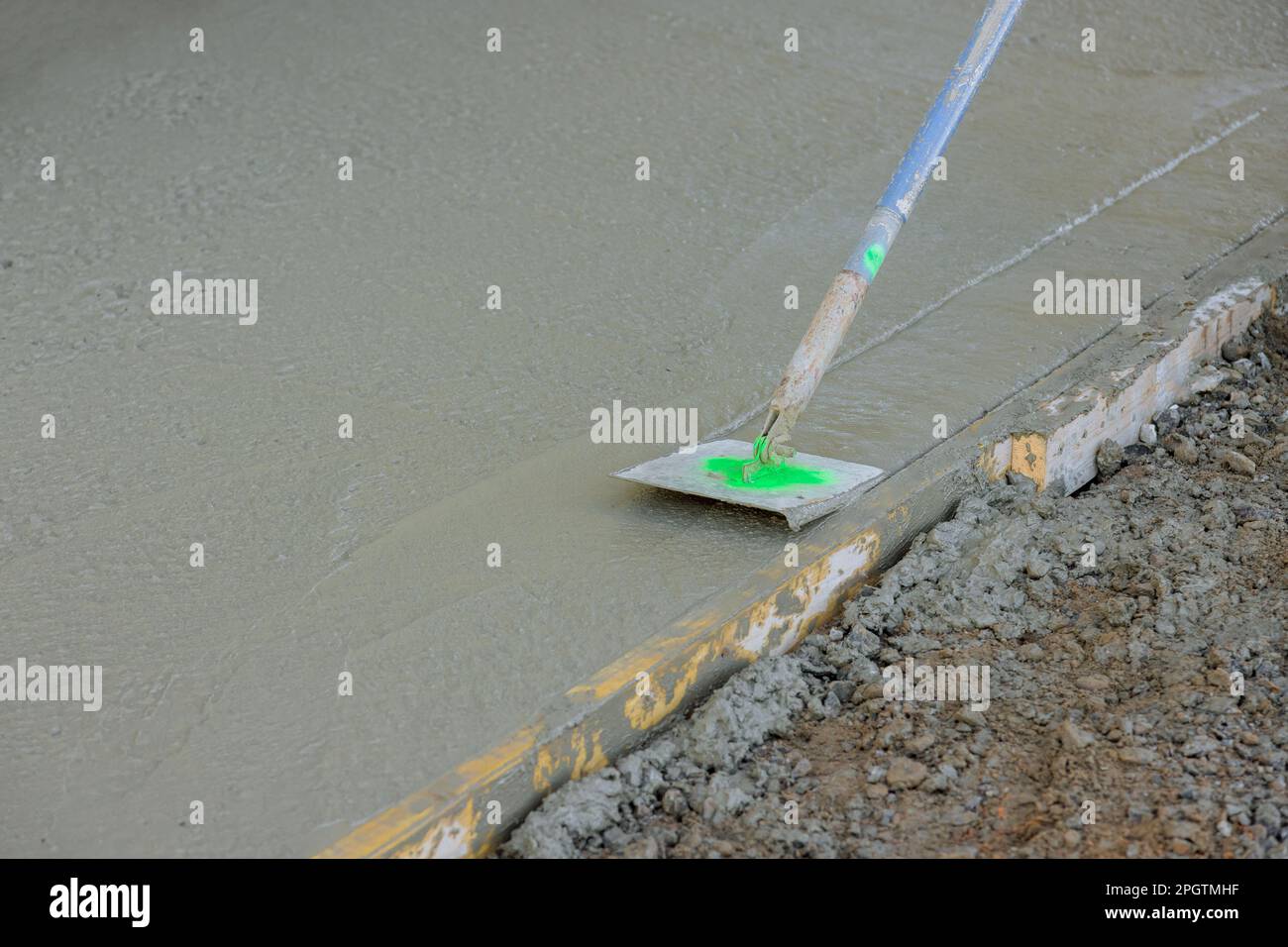 Construction company employee forms corners on freshly cement floor