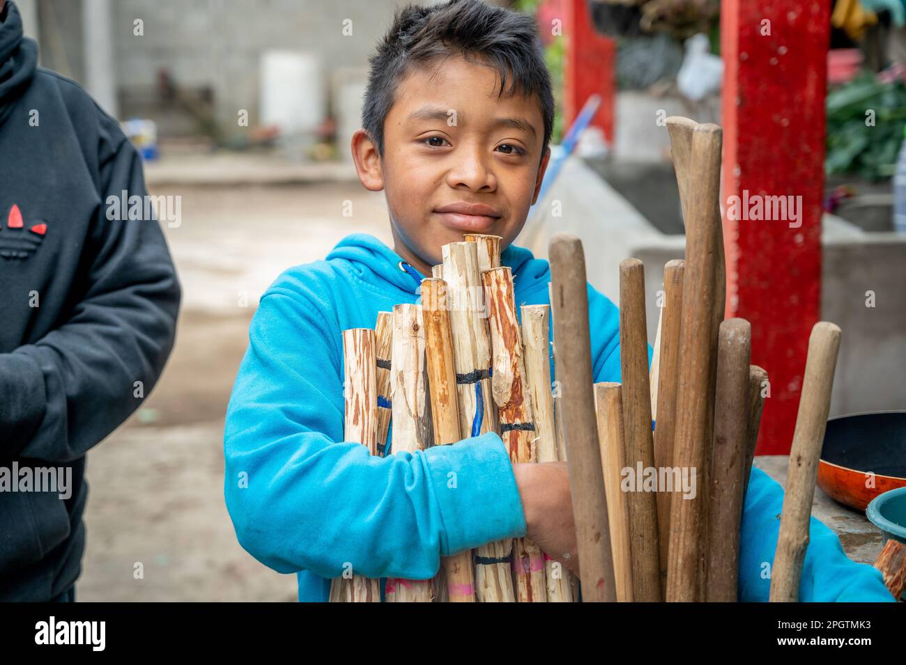 Kid holding hiking sticks in Guatemala Stock Photo
