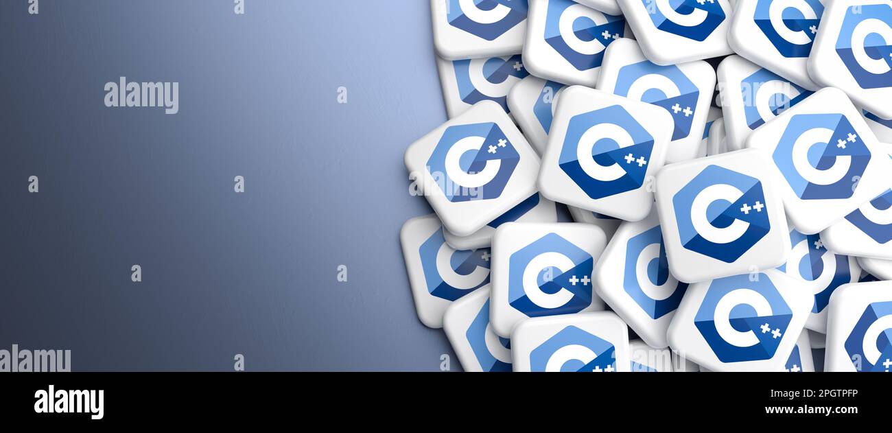 Logos of the programming language C++ on a heap on a table. Web banner ...