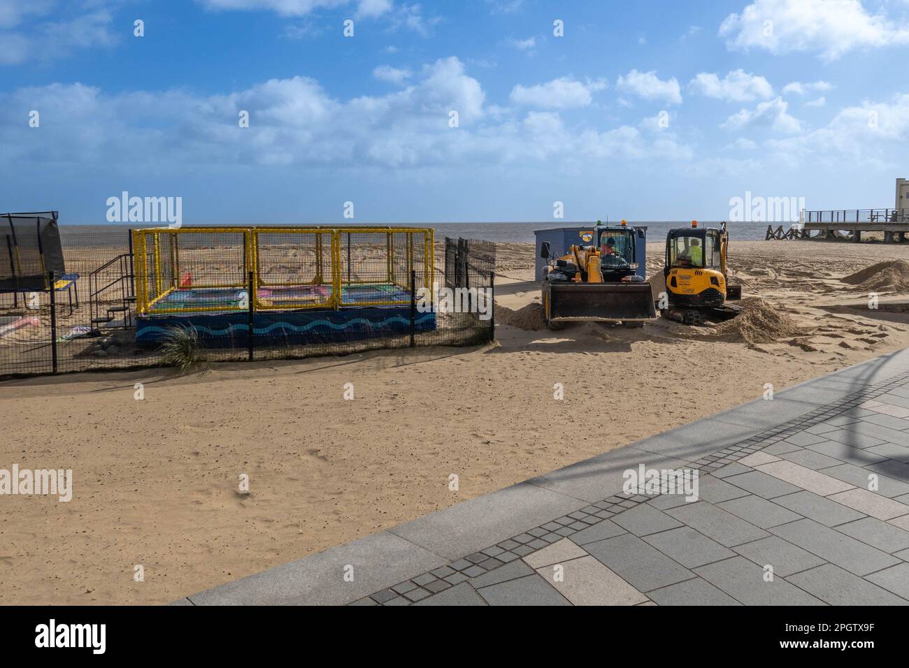 Diggers on Great Yarmouth beach moving sand away from sea walls after the winter storms ready for the summer season Stock Photo