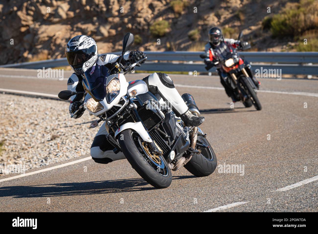 Rider on the asphalt with his bike leaning around a curve Stock Photo ...