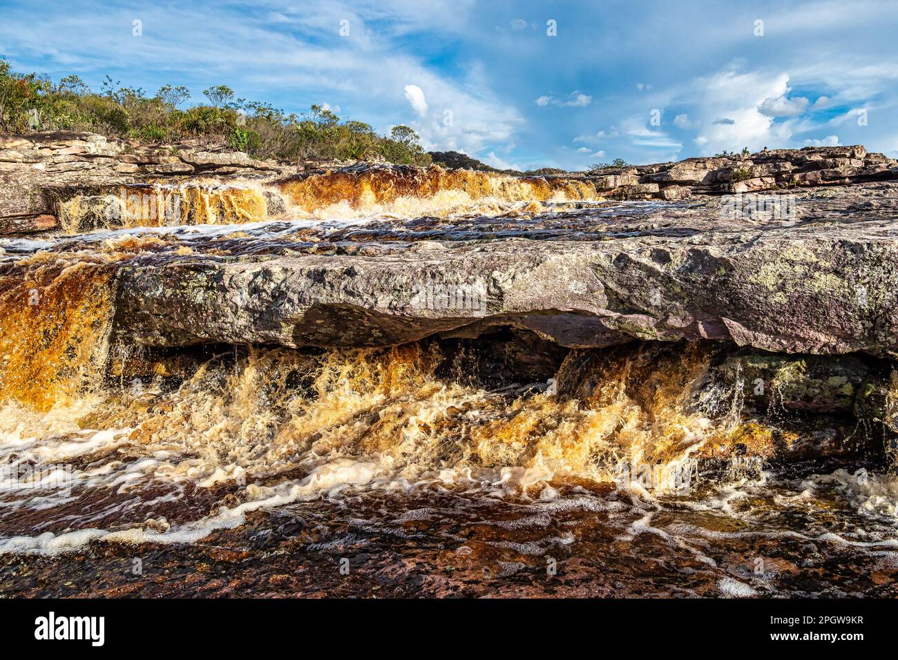 The Tiburtino waterfall in Mucuge, in the Chapada Diamantina, in Bahia, Brazil running over rocks and stones. Sempre Viva park Stock Photo