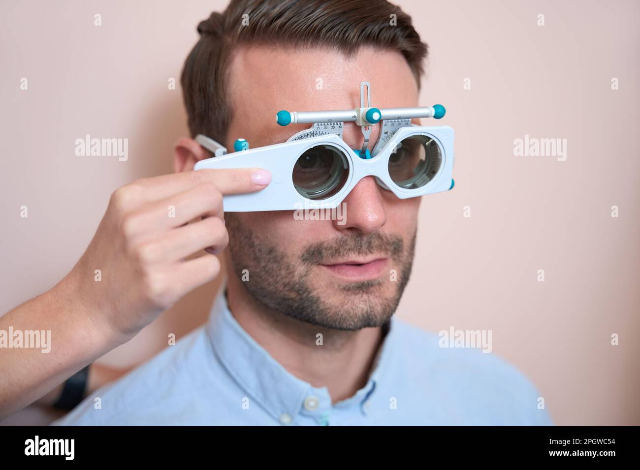 Adorable bearded male is checking his visual acuity is the ...