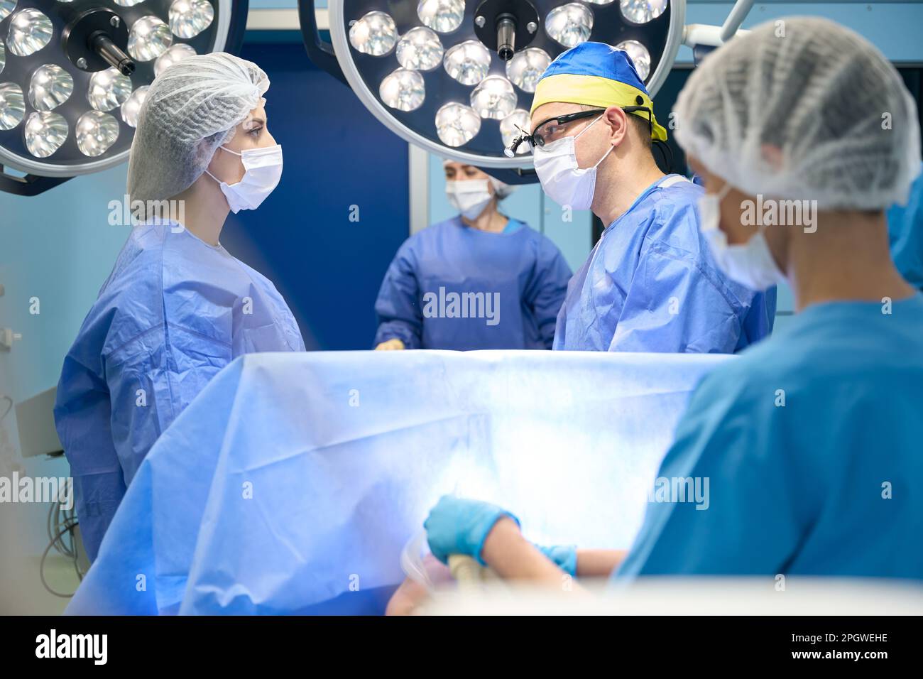 Operating Room Assistant I Modern operating room, the surgeon looks at the assistant Stock Photo ...