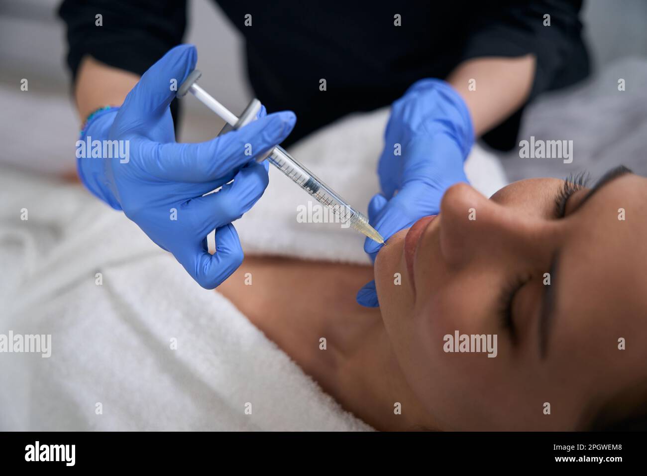 Cosmetologist doing anti-aging injections to beautiful client in salon ...