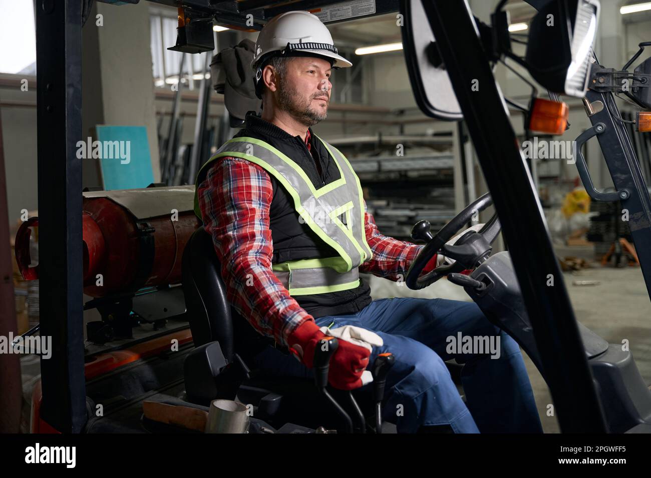 Male sitting in loading truck and working at enterprise Stock Photo - Alamy