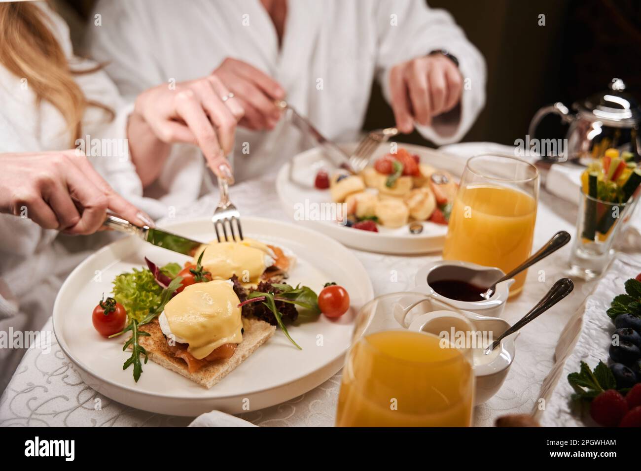 Man and a woman in fluffy bathrobes have romantic breakfast Stock Photo ...