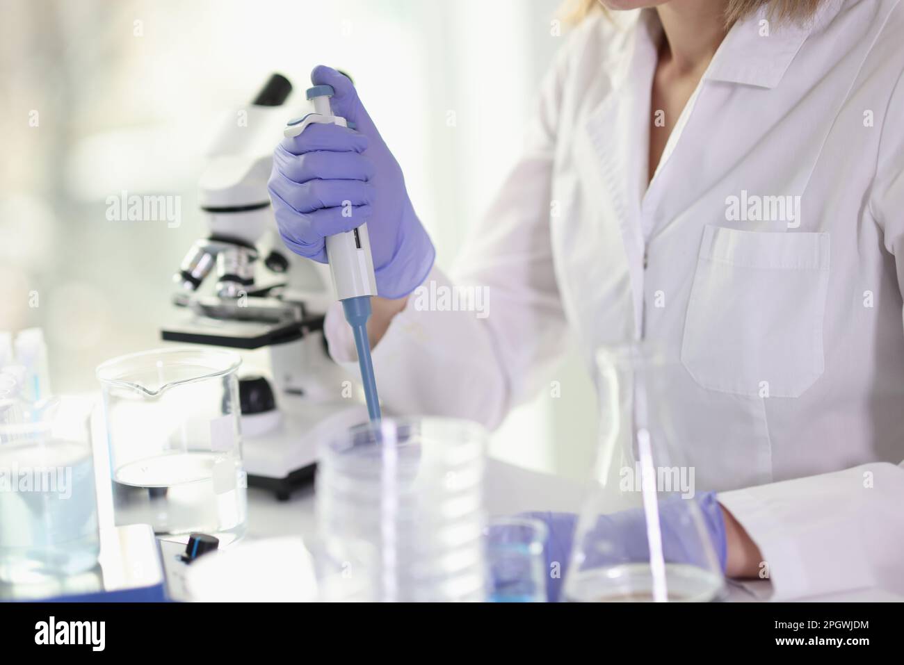 Laboratory worker in uniform does professional research Stock Photo