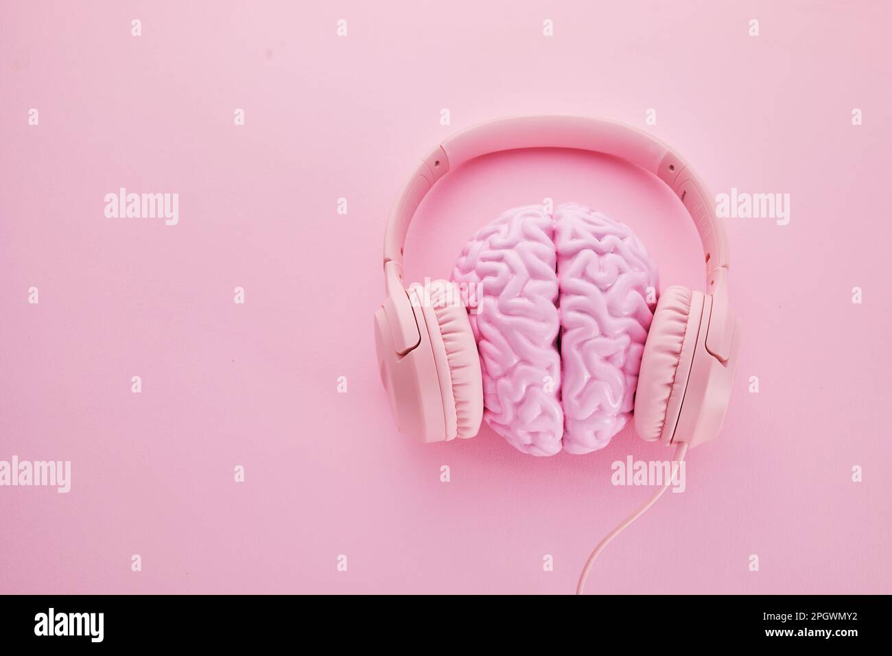 Music brain and musical therapy. Human brain with headphones Stock Photo