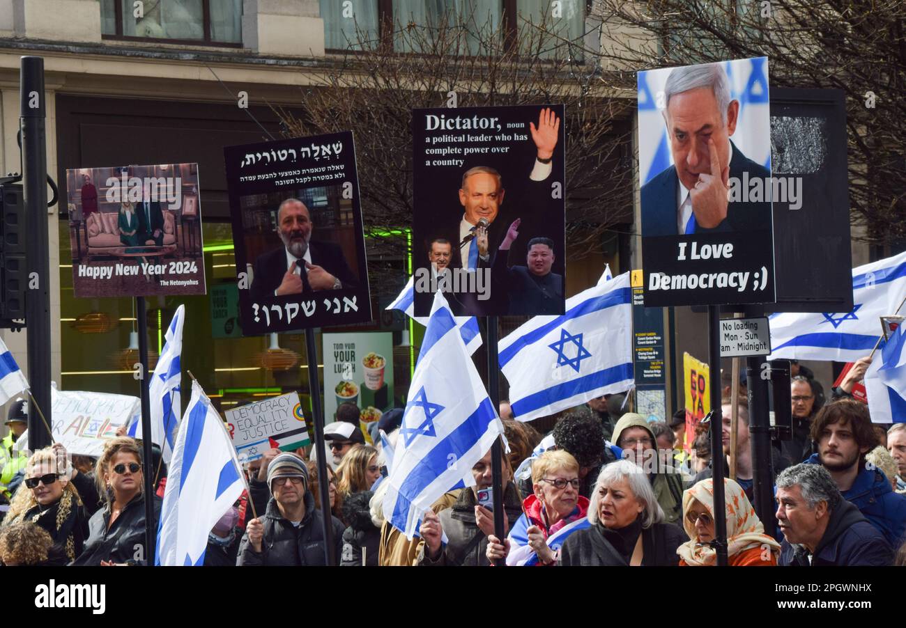 London, UK. 24th Mar, 2023. Protesters hold anti-Netanyahu placards and Israeli flags during the demonstration outside The Savoy Hotel on The Strand. Crowds of British Israelis staged a protest against Benjamin Netanyahu as the Israeli Prime Minister visited the UK. Credit: SOPA Images Limited/Alamy Live News Stock Photo