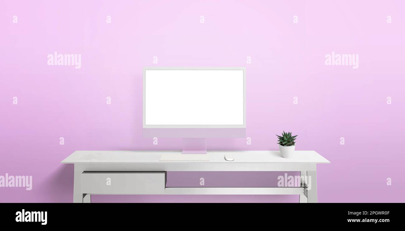 Computer display on white work desk with isolated screen for web page presentation. Pink wall with copy space in background Stock Photo