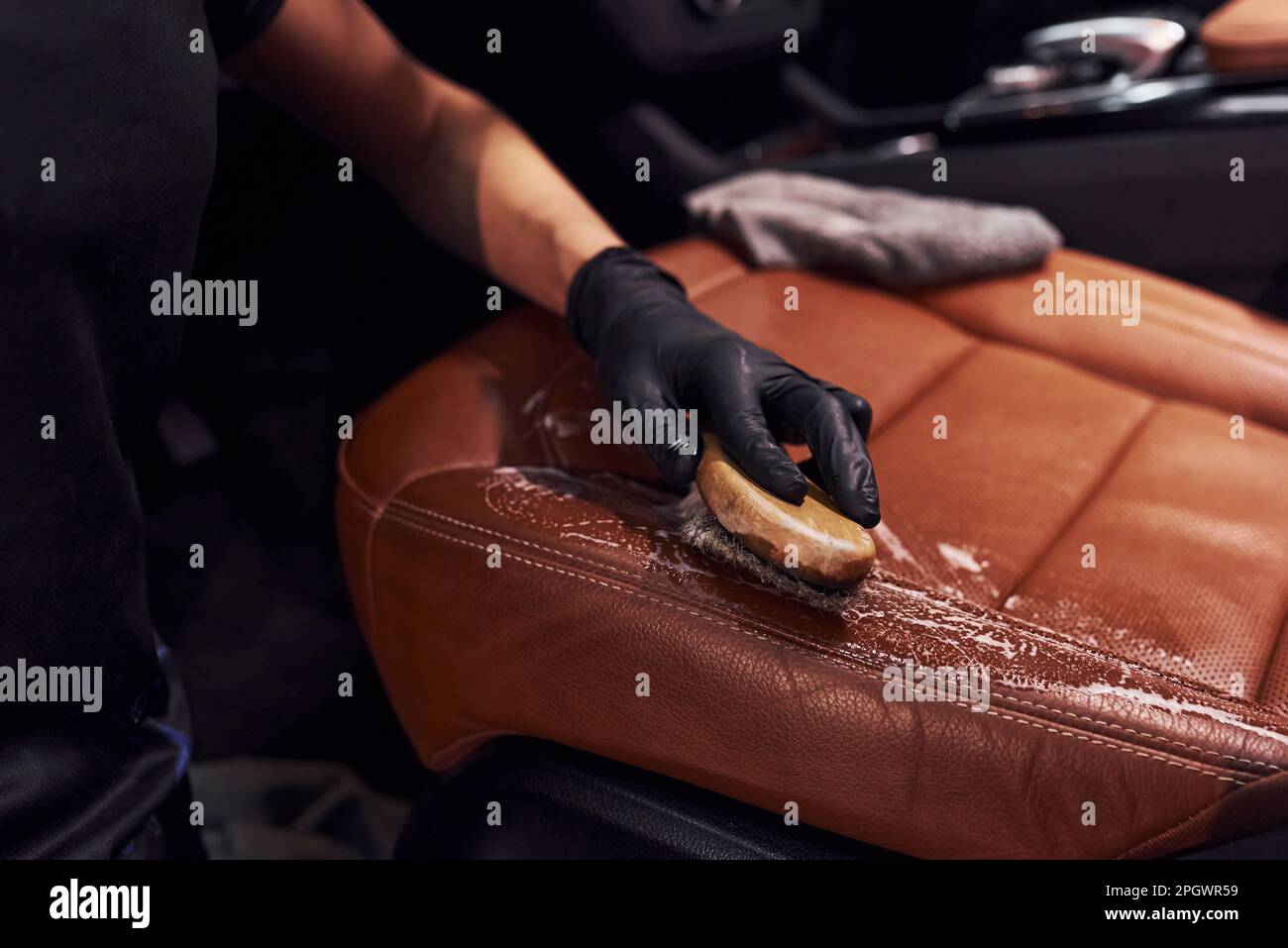 Taking care about brown colored seats. Modern black automobile get