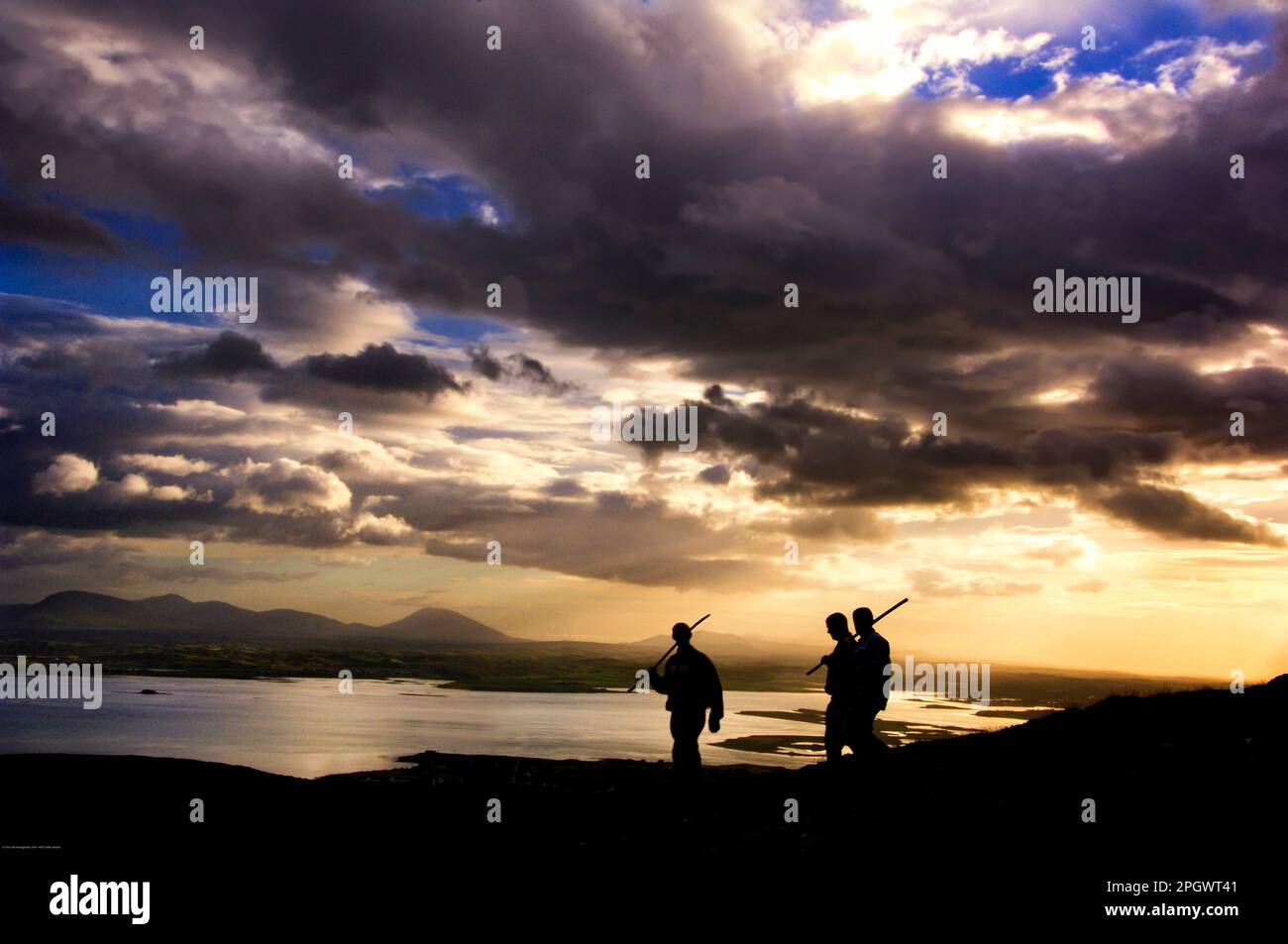 Three walkers on the Croagh Patrick Reek,Clew Bay, Co. Mayo, Ireland Stock Photo