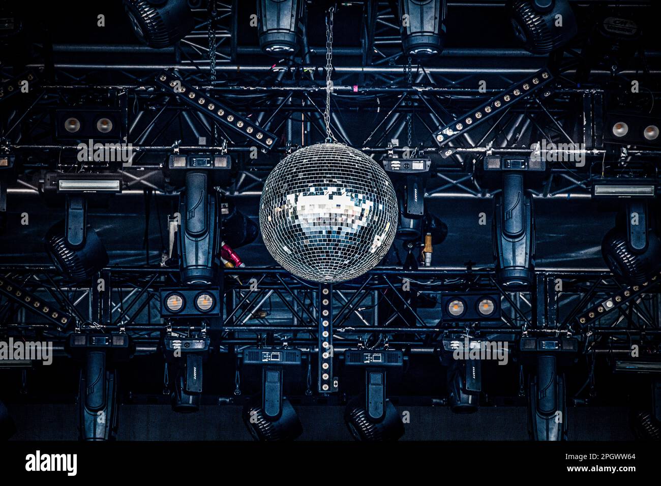 Disco ball and concert spotlights on top of a concert stage at a music