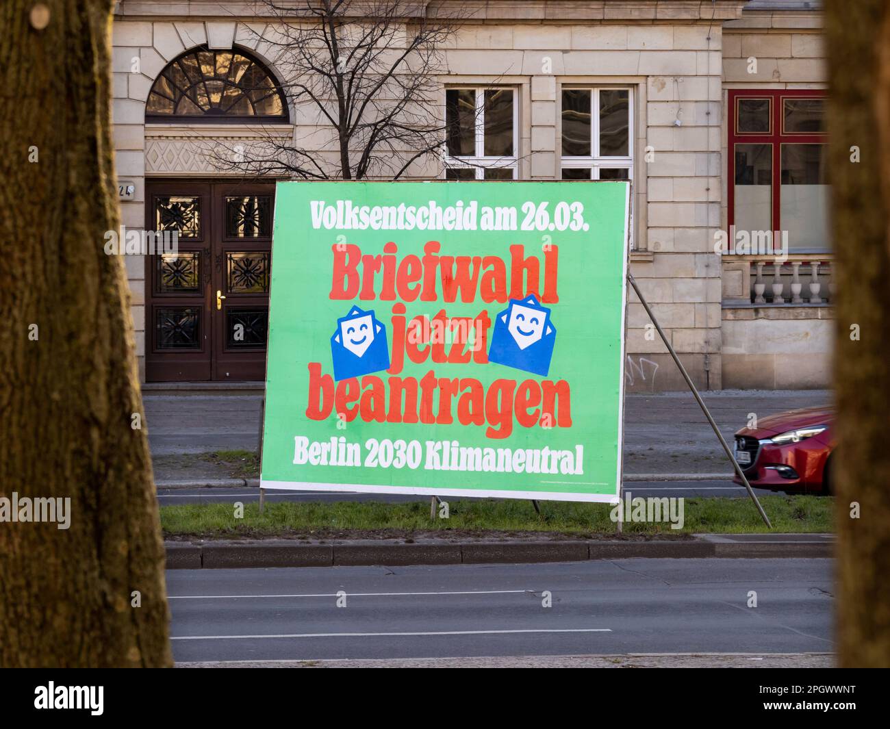 Postal voting advertisement placard in the middle of a street. Vote for climate neutrality until 2030 in a public referendum on 26 March 2023. Stock Photo